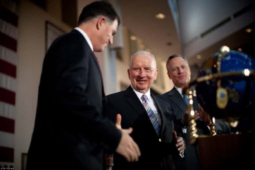 Michael Dell (from left), Ross Perot and Ross Perot Jr. celebrate with Perot Systems...