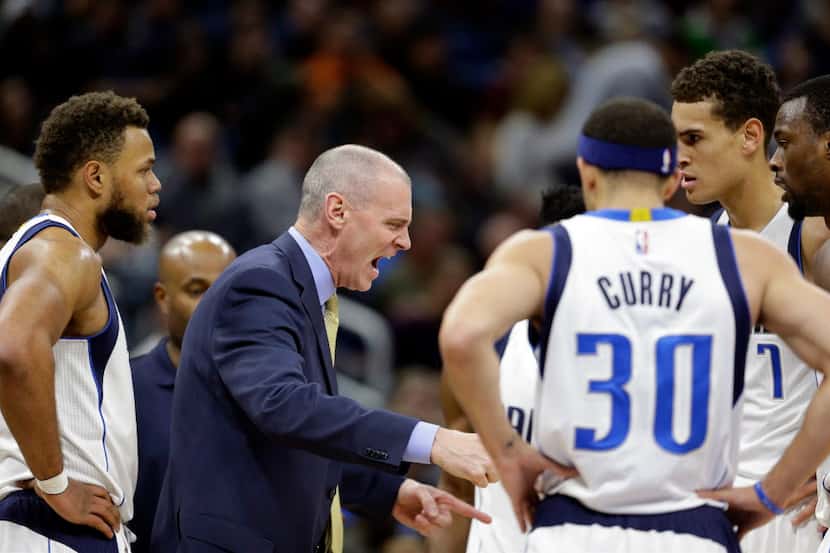 Dallas Mavericks head coach Rick Carlisle, center, has words with his players during a...