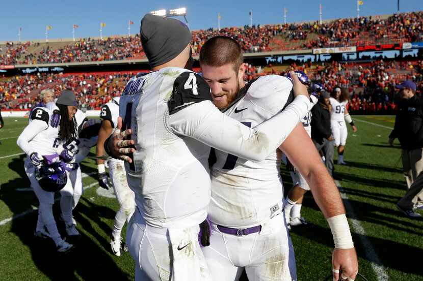 TCU quarterback Casey Pachall, left, gets a hug from teammate Jon Koontz after their 21-17...