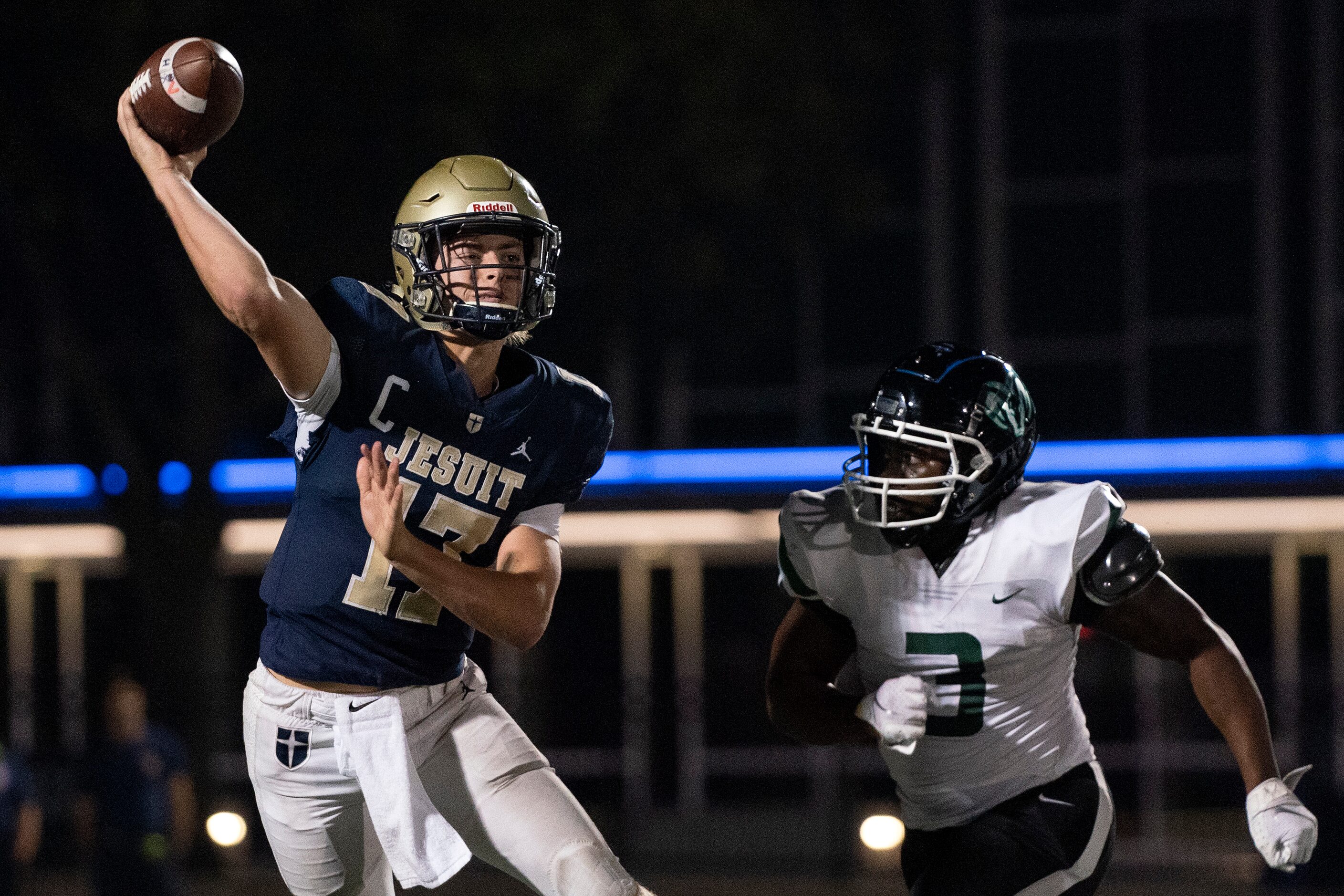 Jesuit senior quarterback Gage Roy (17) throws a pass as he scrambles away from Richardson...