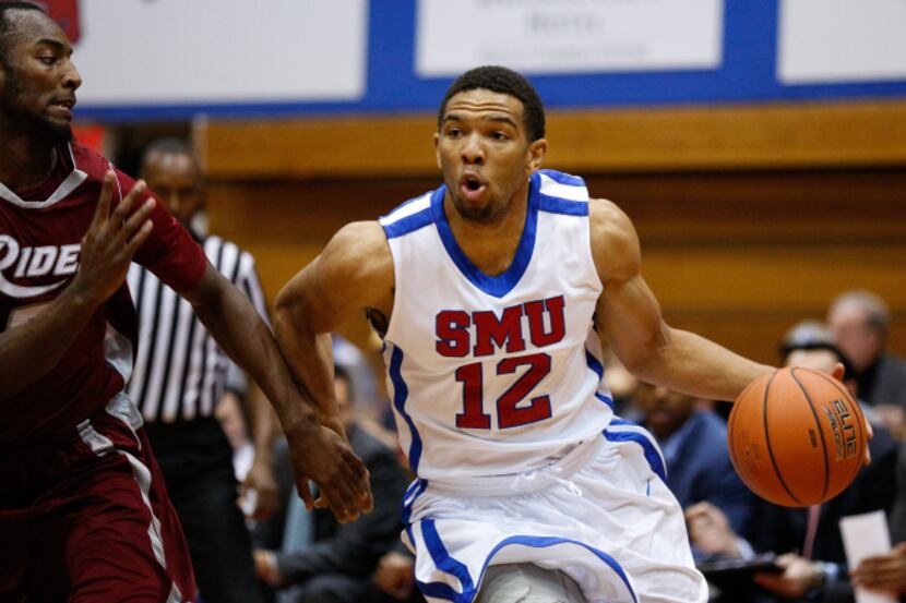 Southern Methodist University's Nick Russell (12) drives past Rider's defense at the Moody...