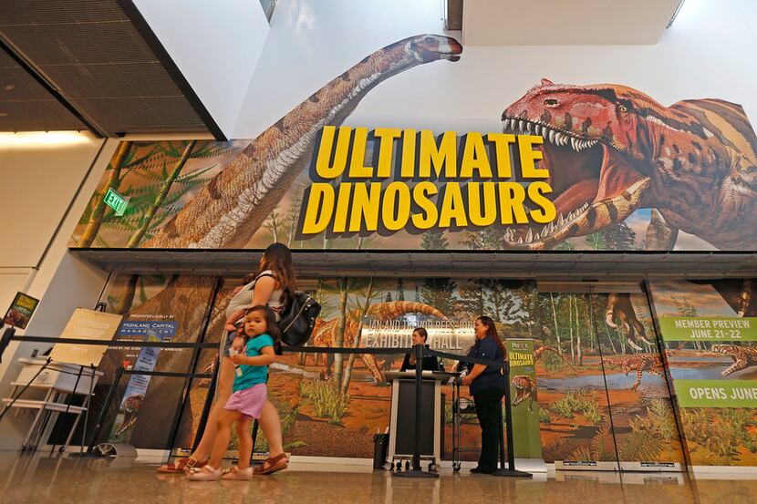 Visitors make their way to enter the new dinosaur exhibit Ultimate Dinosaurs at Perot Museum...