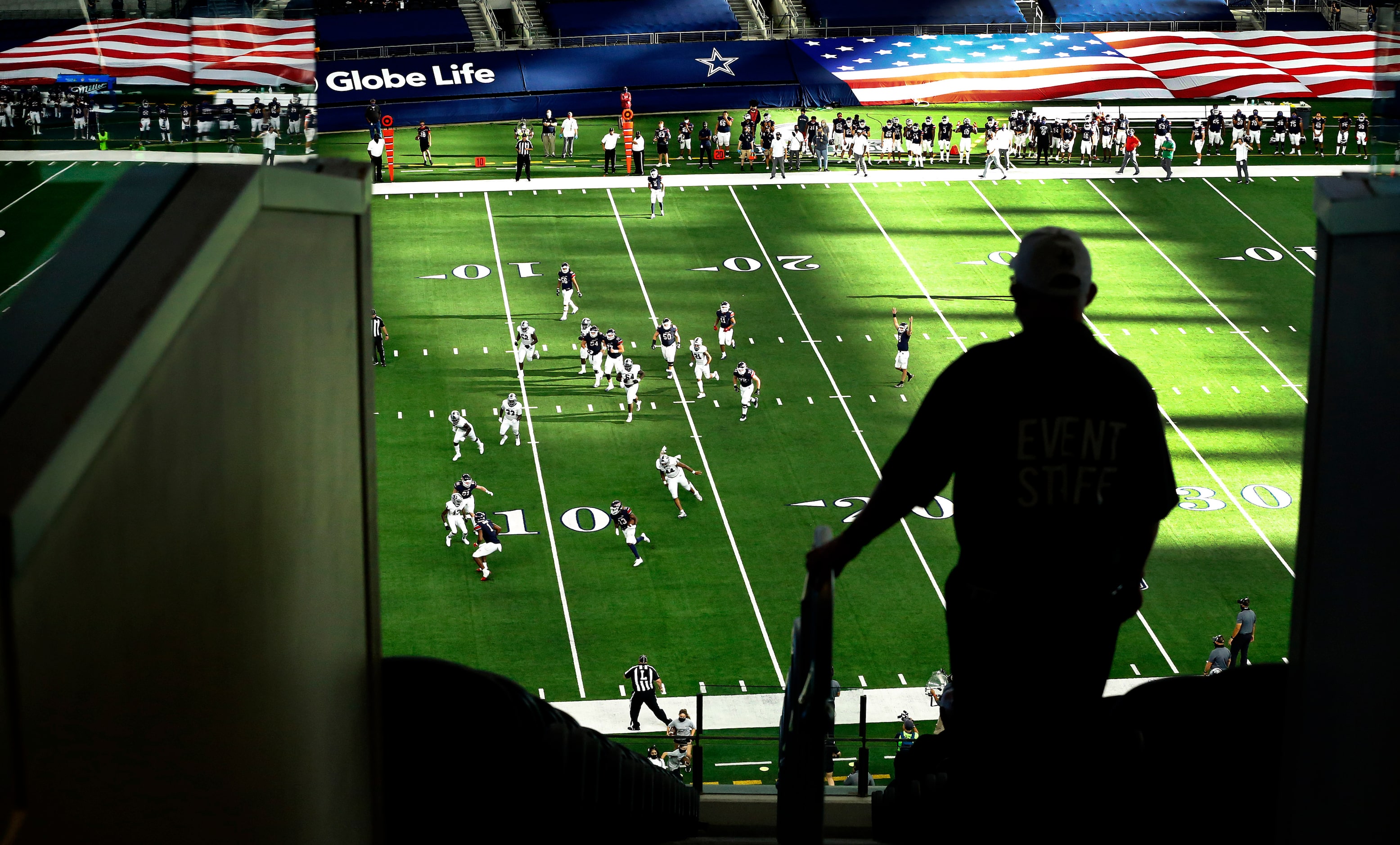 An usher watches as Denton Ryan running back Keori Hicks (13) races for a third quarter...