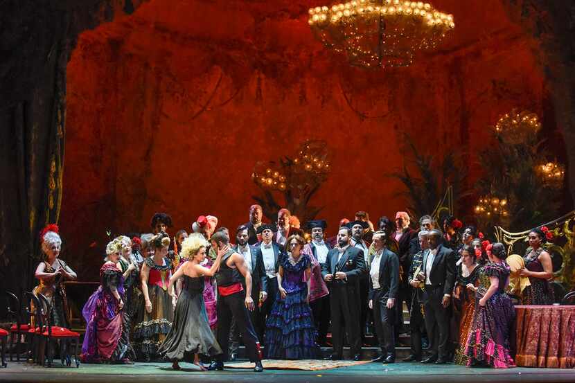 Dancers entertain a party crowd in the Dallas Opera's La traviata, which continues through...