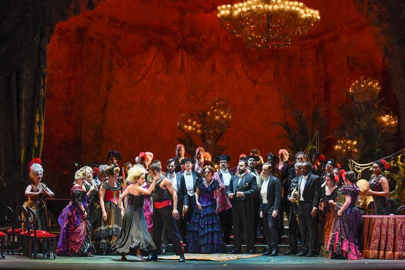 Dancers entertain a party crowd in the Dallas Opera's La traviata, which continues through...
