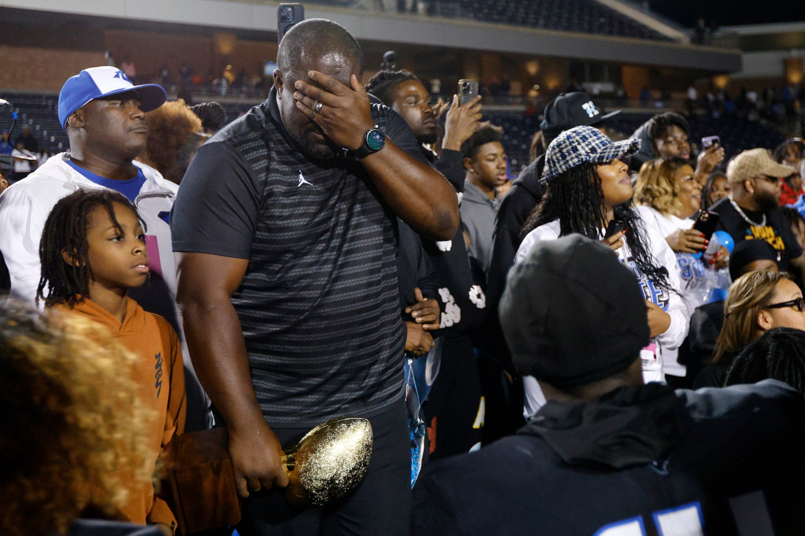 North Crowley head coach Ray Gates is overcome with emotion as he prepares to speak to his...