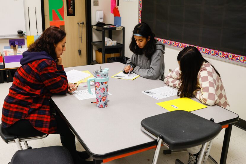 Teacher Elvi Chavez-Cisneros (left) tutors Sarah Martinez-Valenciana and Yaretzy Delgadillo...