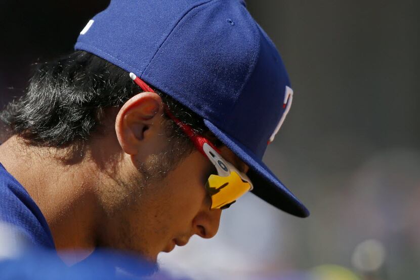 Texas Rangers starting pitcher Yu Darvish (11) hangs his head in the dugout at the end of...