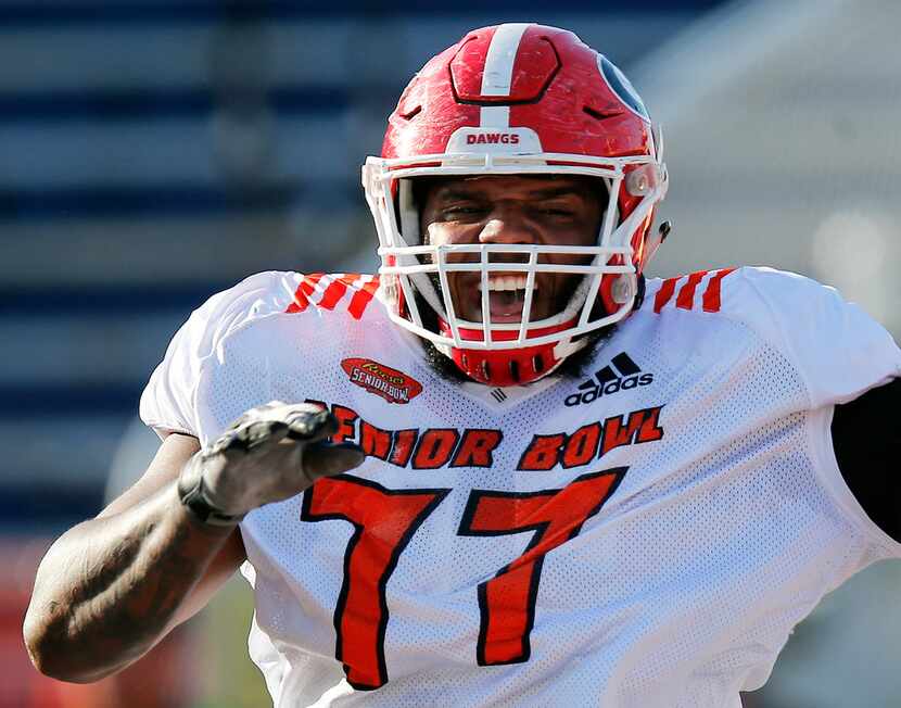 South Team offensive guard Isaiah Wynn, of Georgia, reacts to a drill during a practice...