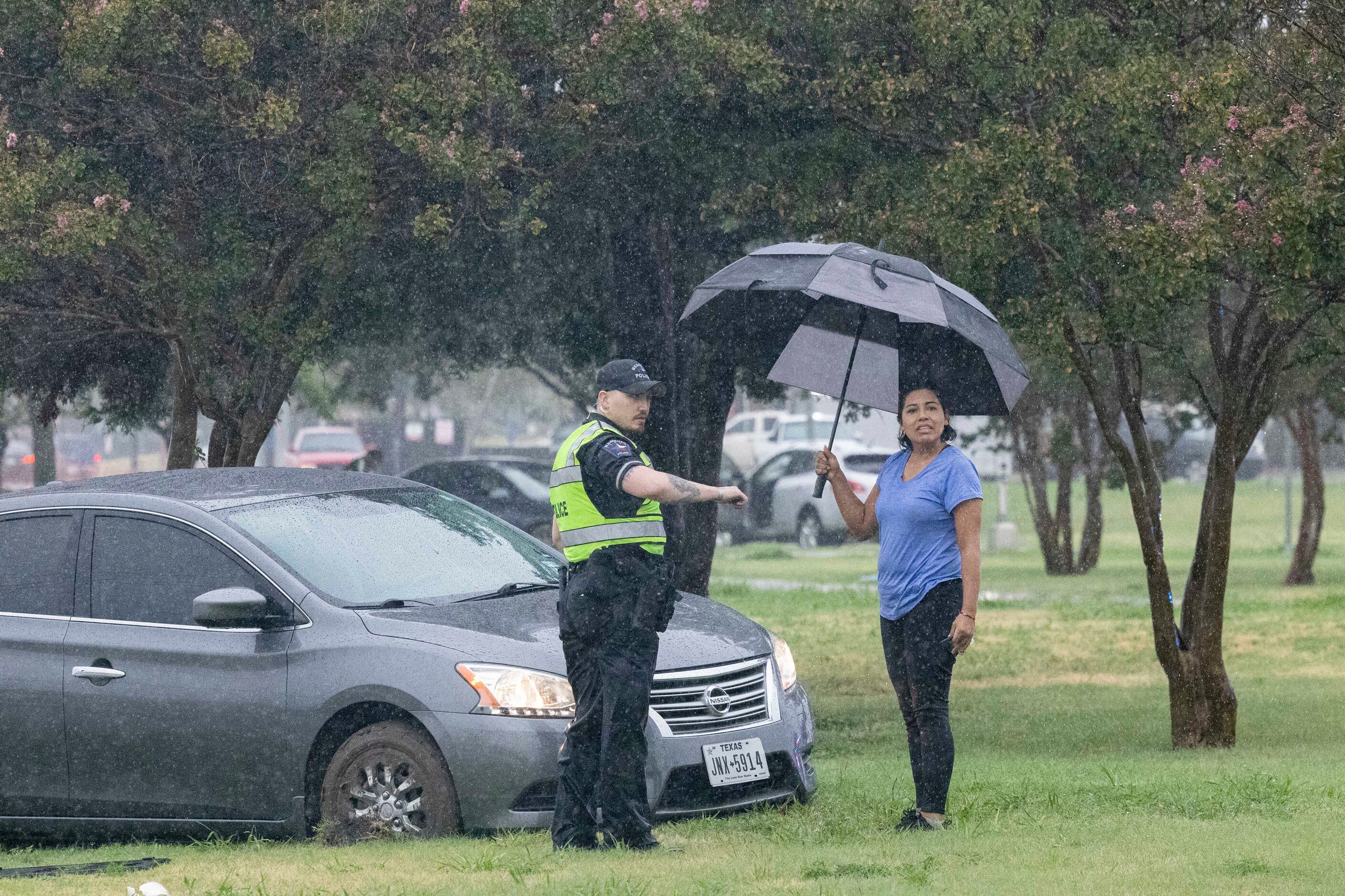 Mesquite police officer Newsom talks to stranded motorist Alma Sandate after getting stuck...