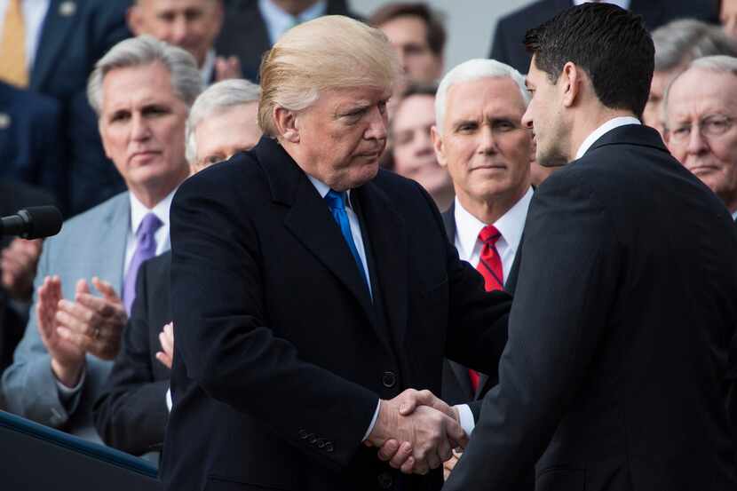 President Donald Trump, flanked by Speaker of the House Rep. Paul Ryan, R-Wis. and Chairman...