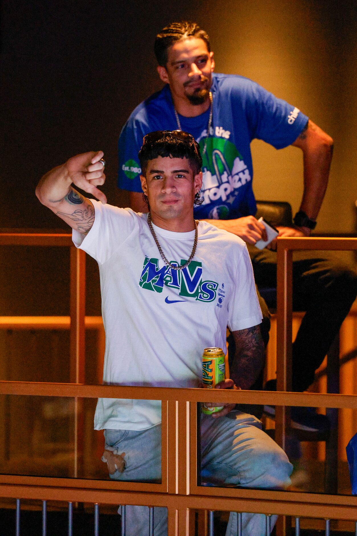 Dallas Mavericks fan Josh Espinosa holds up a thumbs down after the San Antonio Spurs...