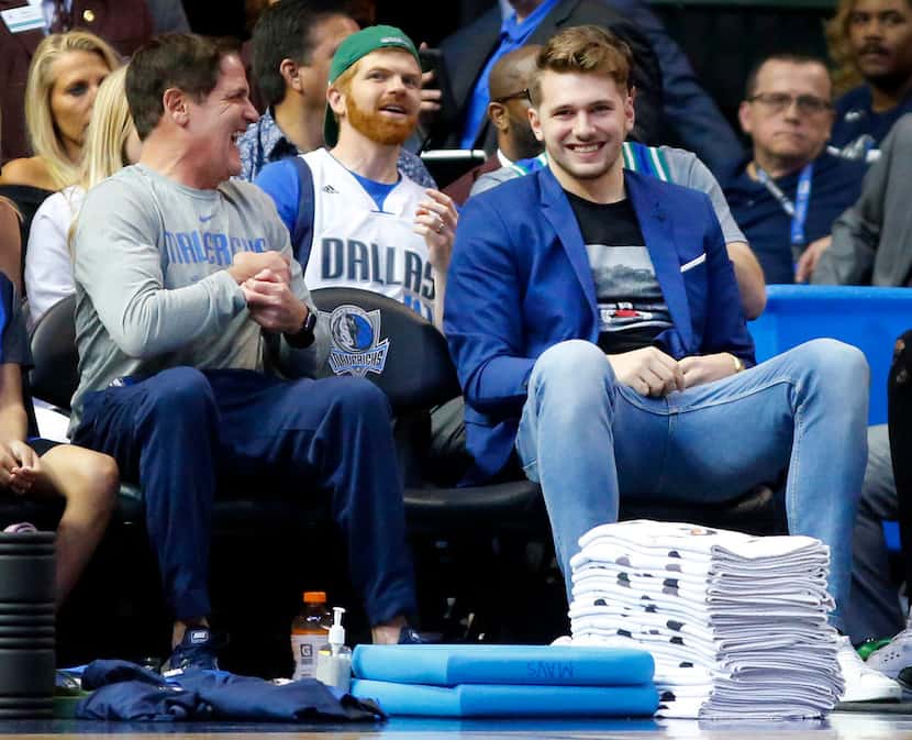 Dallas Mavericks owner Mark Cuban (left) and forward Luka Doncic share a laugh during the...