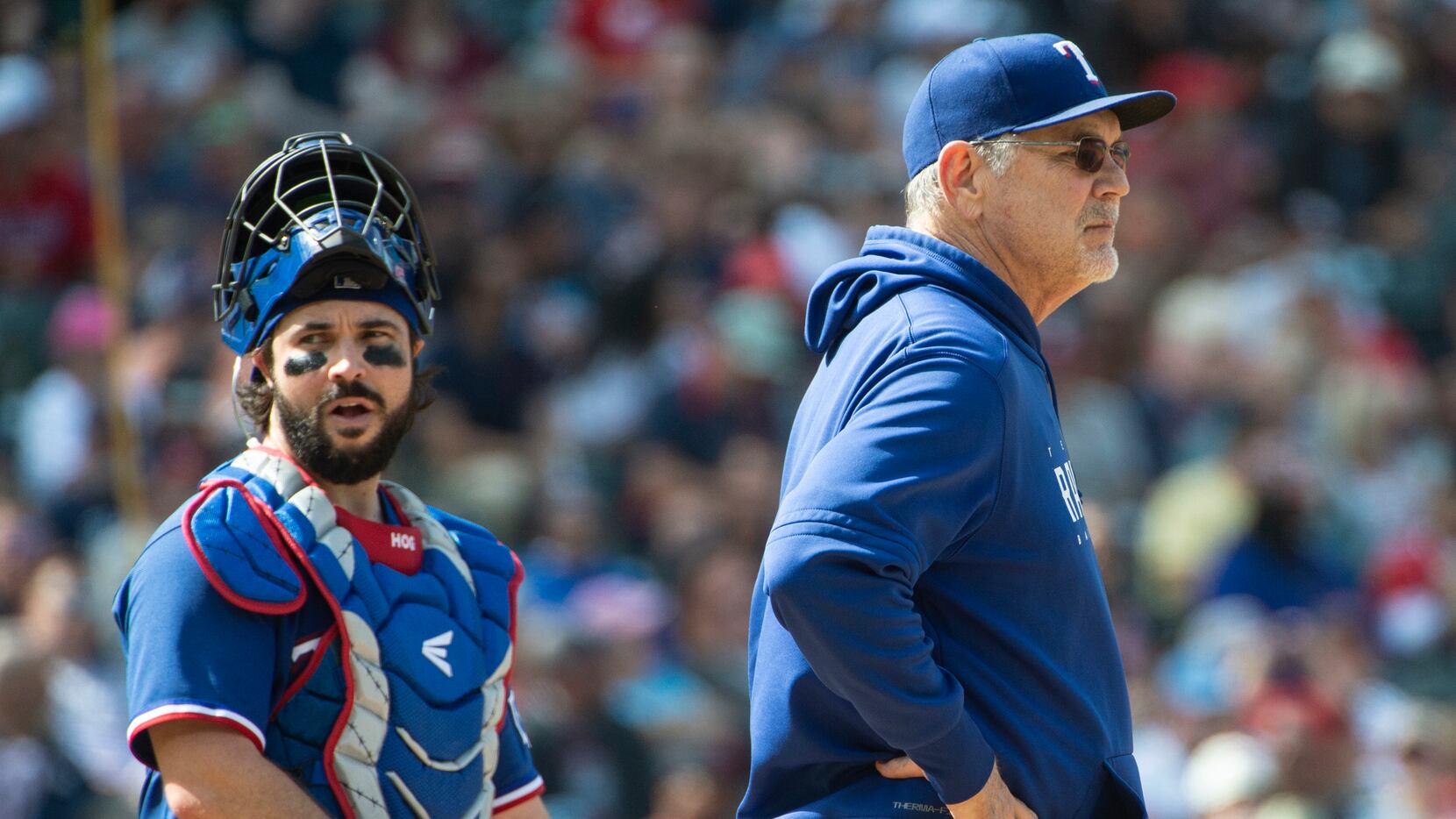 Texas Rangers manager Bruce Bochy, right, waits for a new pitcher as Austin Hedges stands by...
