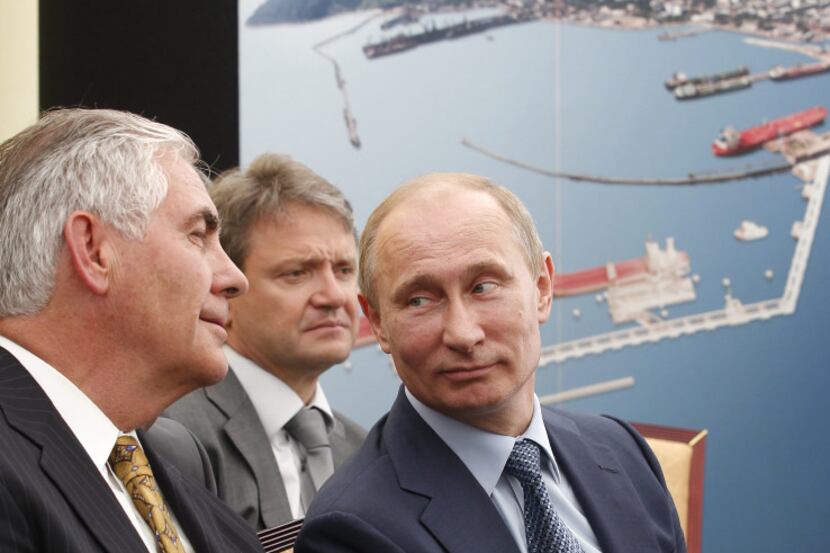 Russian President Vladimir Putin, right, and Exxon Mobil Corp. CEO Rex Tillerson, left,...