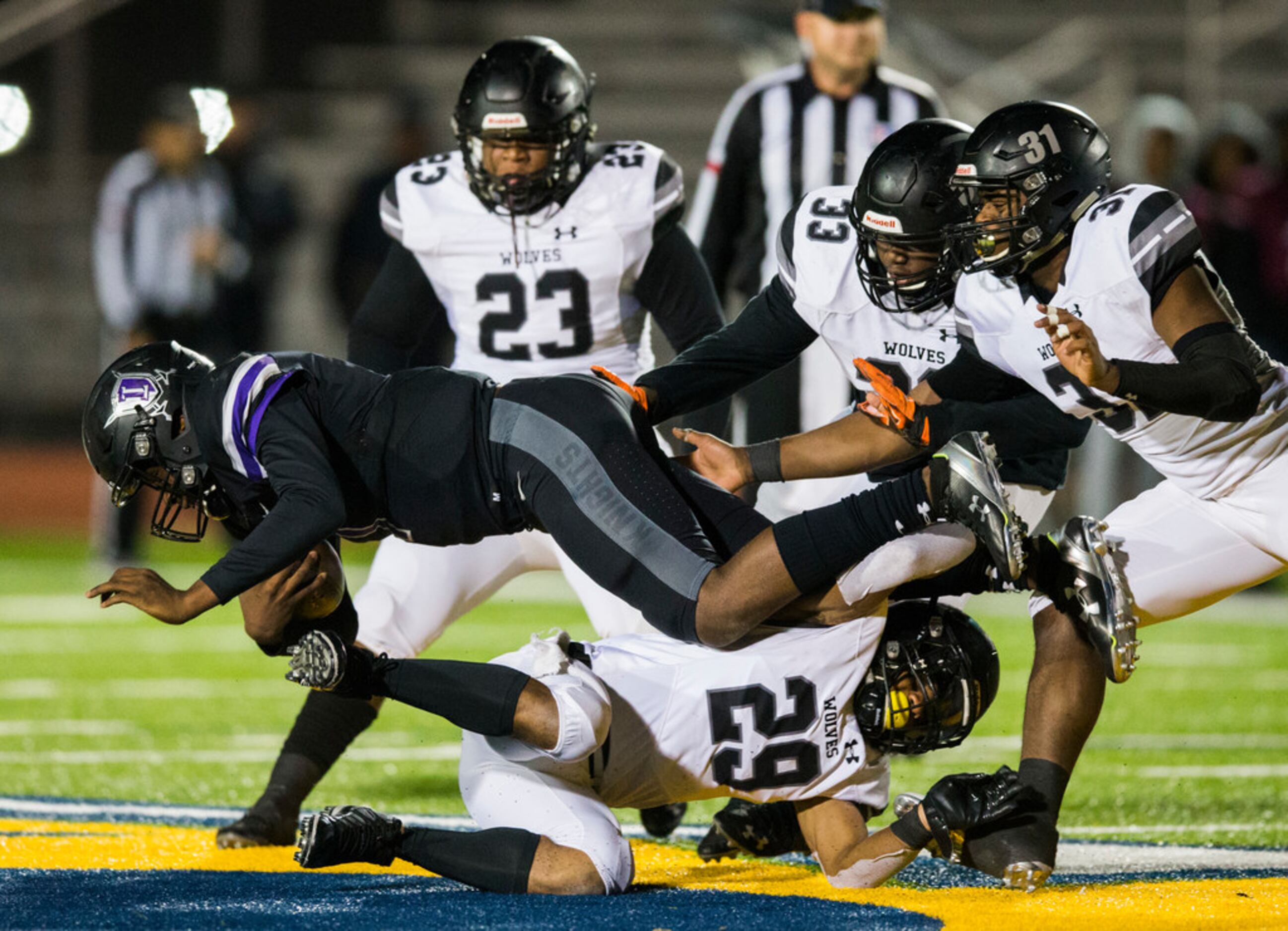 Frisco Independence quarterback Braylon Braxton (1) is tackled by Mansfield Timberview...