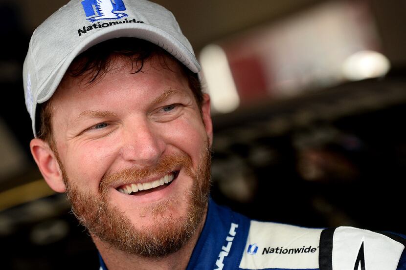 NASCAR driver Dale Earnhardt Jr. laughs as he talks with a reporter following the final...