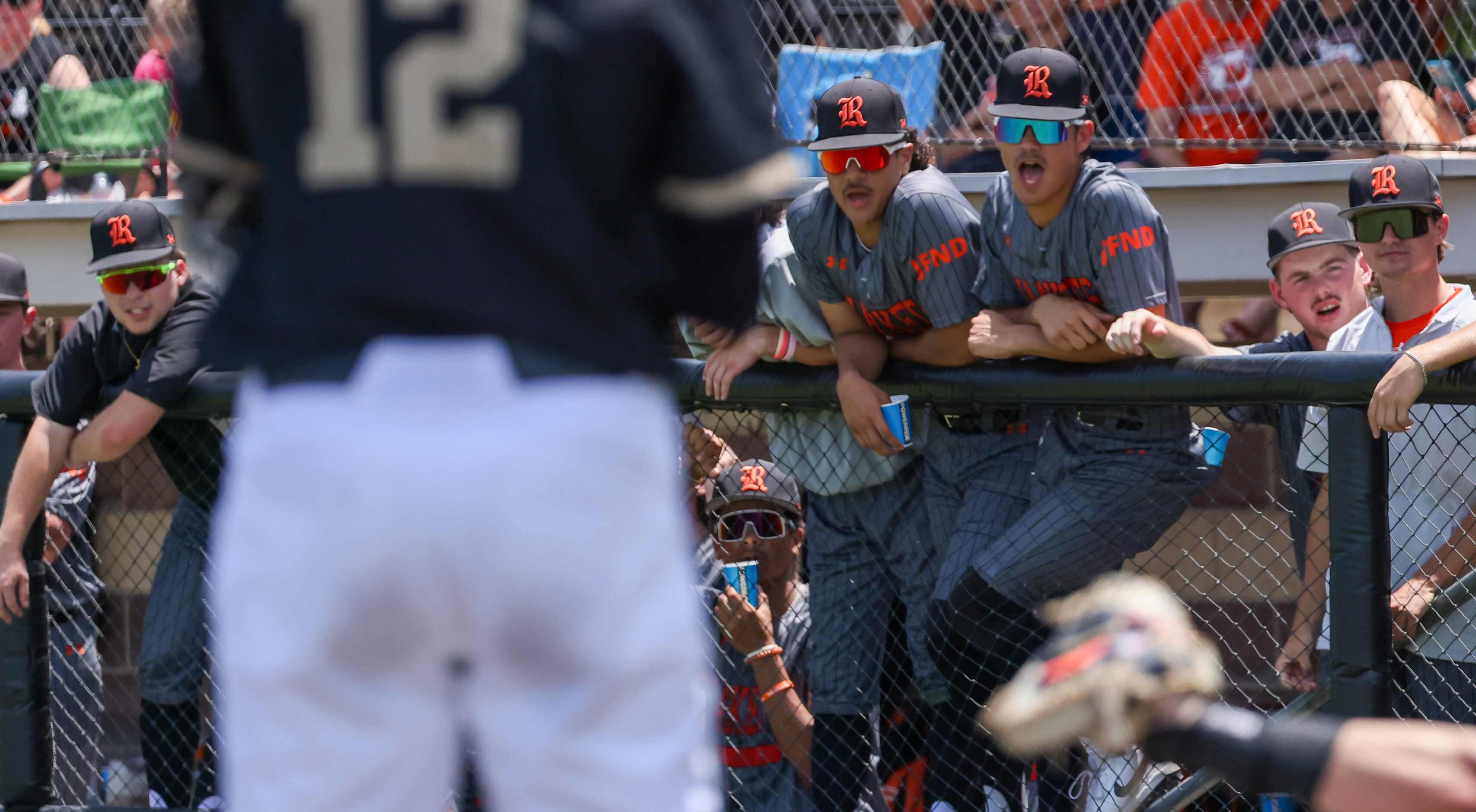 Rockwall players cheer from the dugout for a strike against Mansfield during an area round...