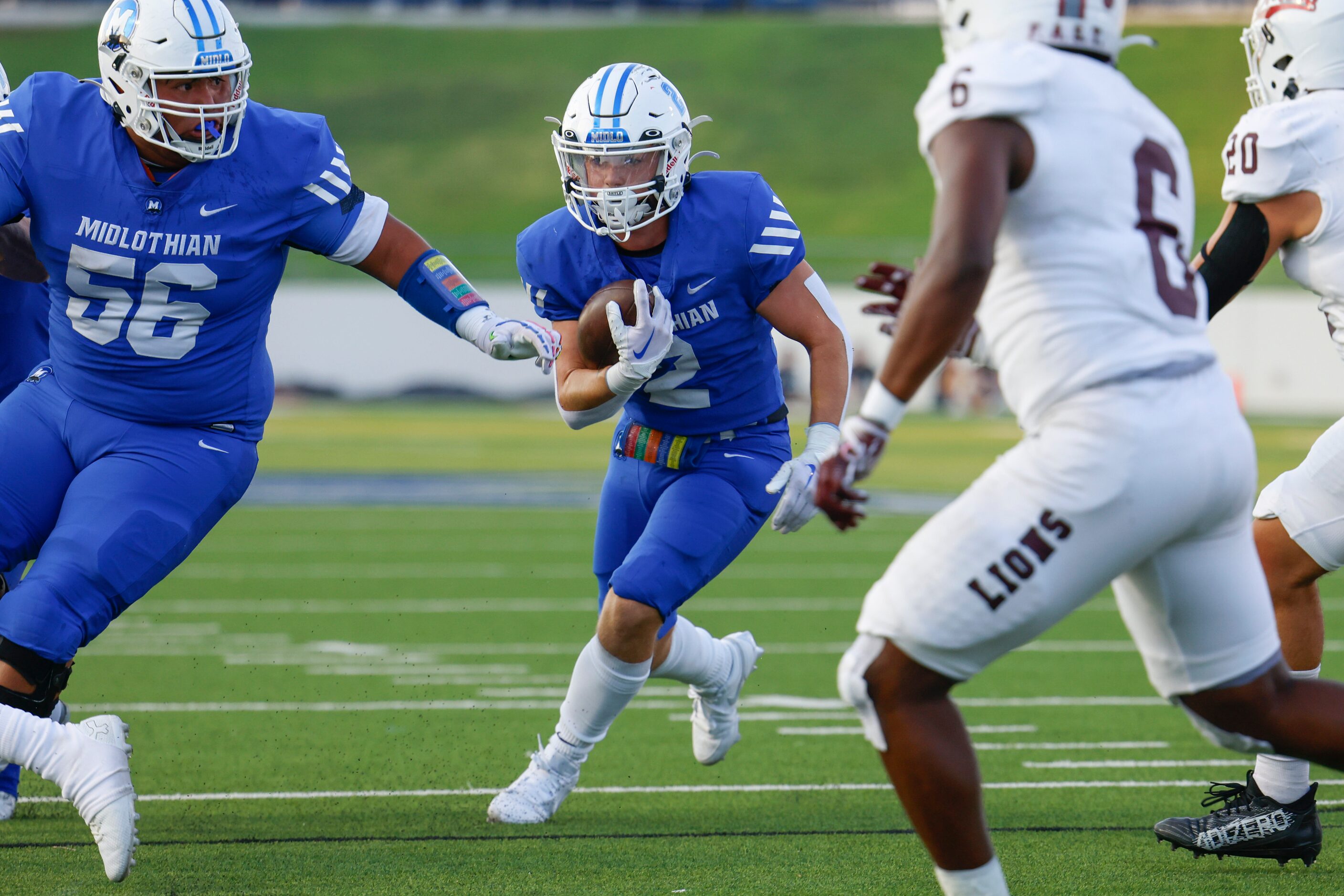 Midlothian high’s Slater Callahan (2) runs for a yardage during a football game against...