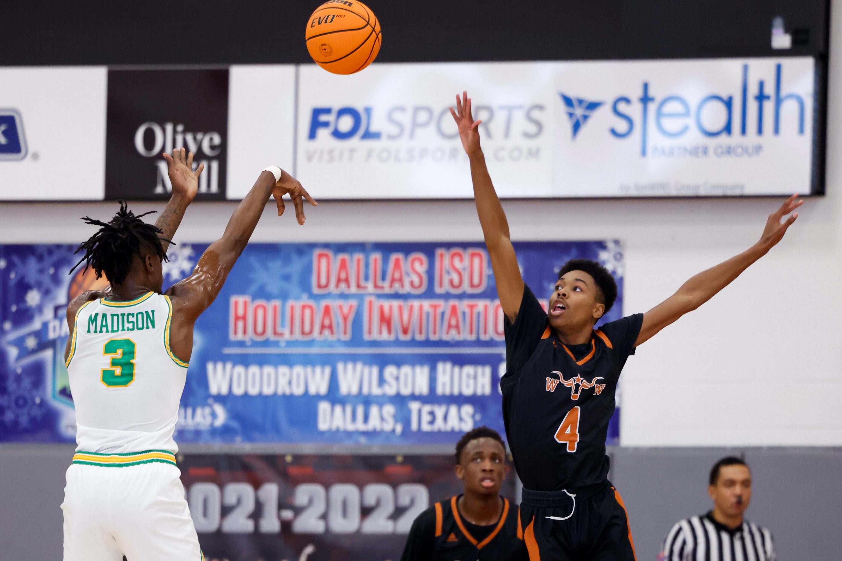 Madison forward Leonard Miles IV (3) attempts a shot over W.T. White guard James Bates (4)...