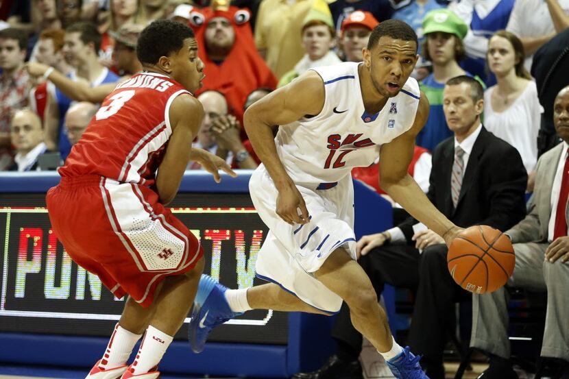 Southern Methodist Mustangs guard Nick Russell (12) drives past Houston Cougars guard Jaaron...