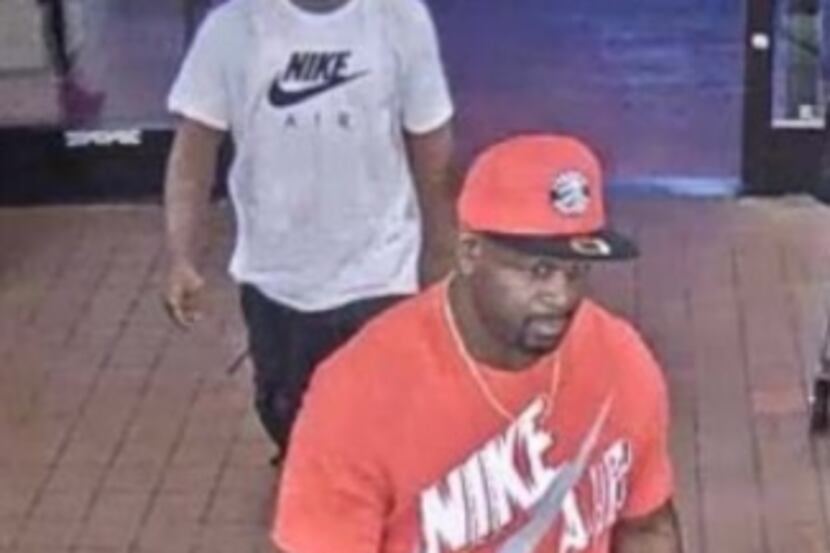 Surveillance image of two suspects in a purse snatching. 