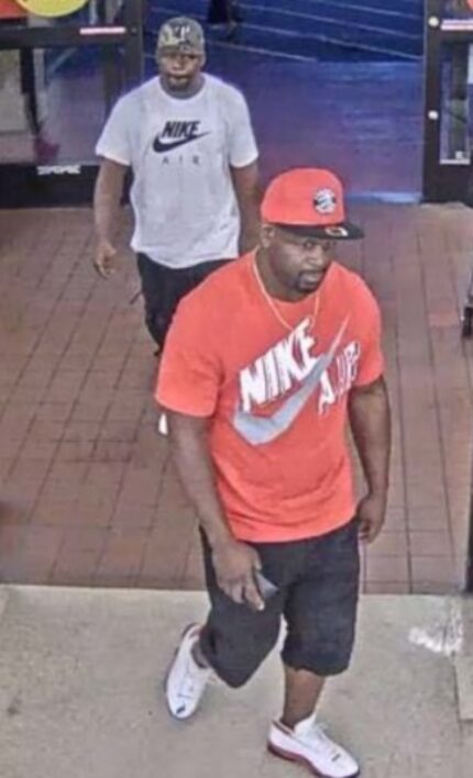 Surveillance image of two suspects in a purse snatching. 