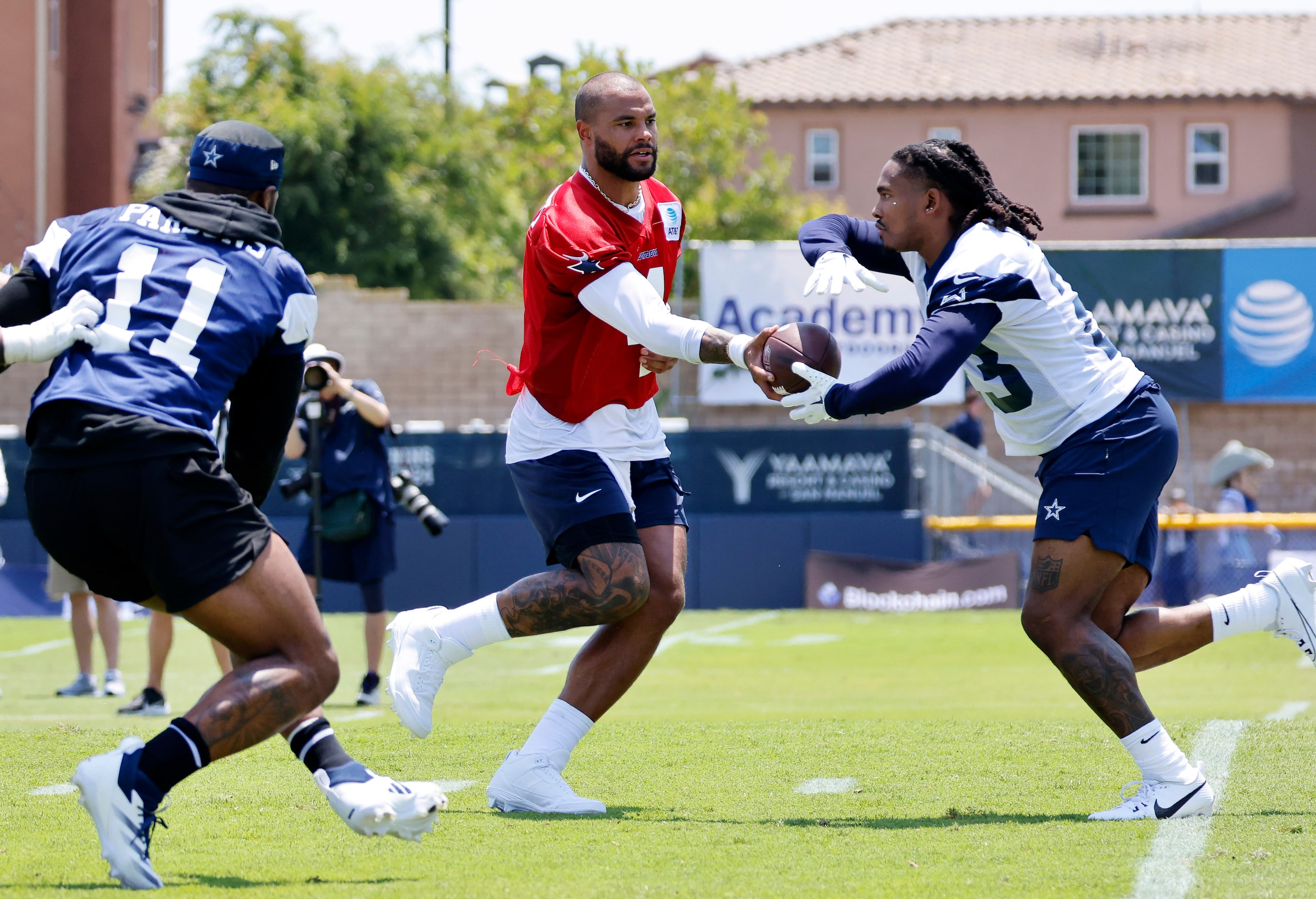 Dallas Cowboys quarterback Dak Prescott (4) hands the ball off to running back Rico Dowdle...