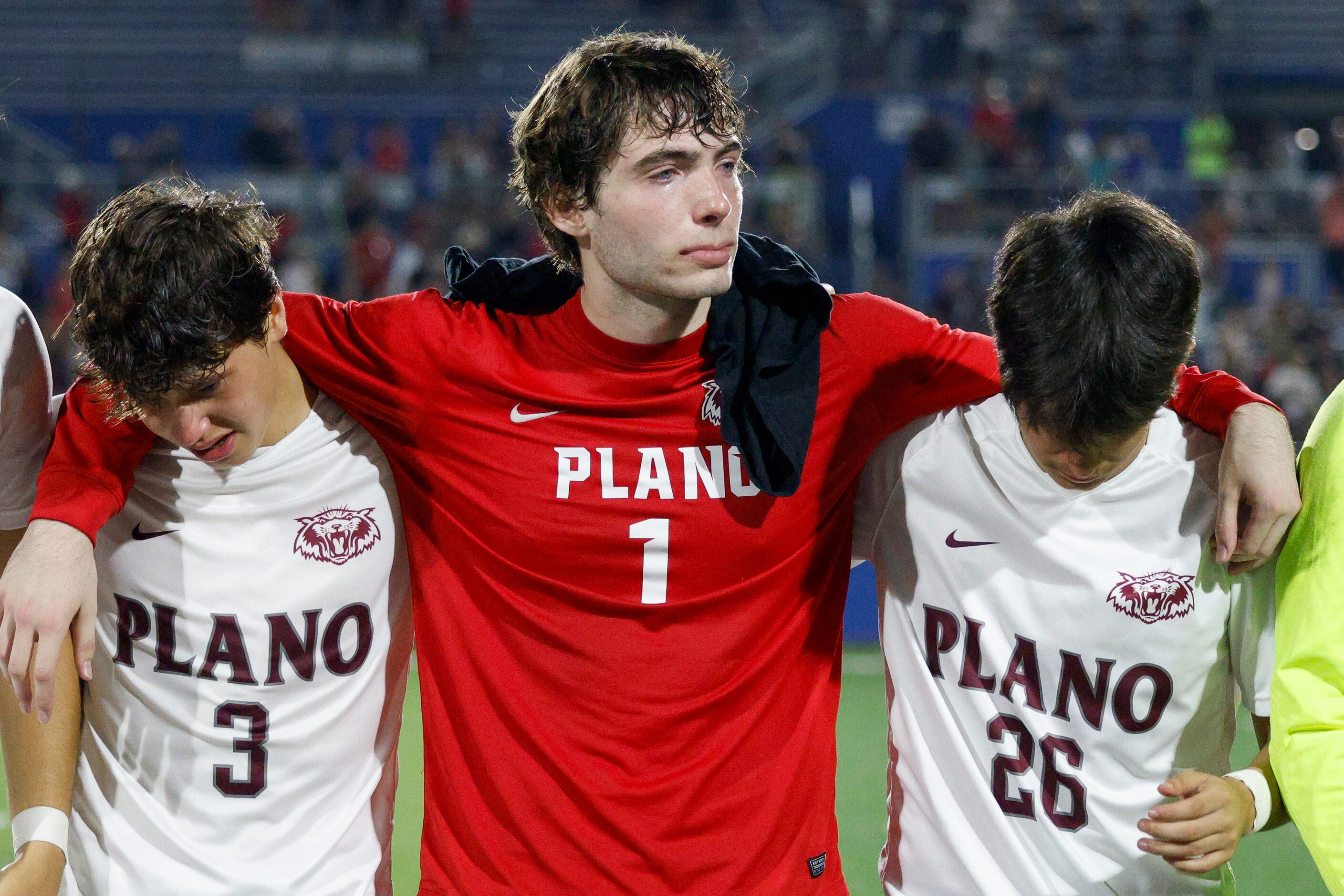 Plano goalkeeper Henry Huffstetler (1) hangs his arms over Plano midfielder Aiden Ussery (3)...