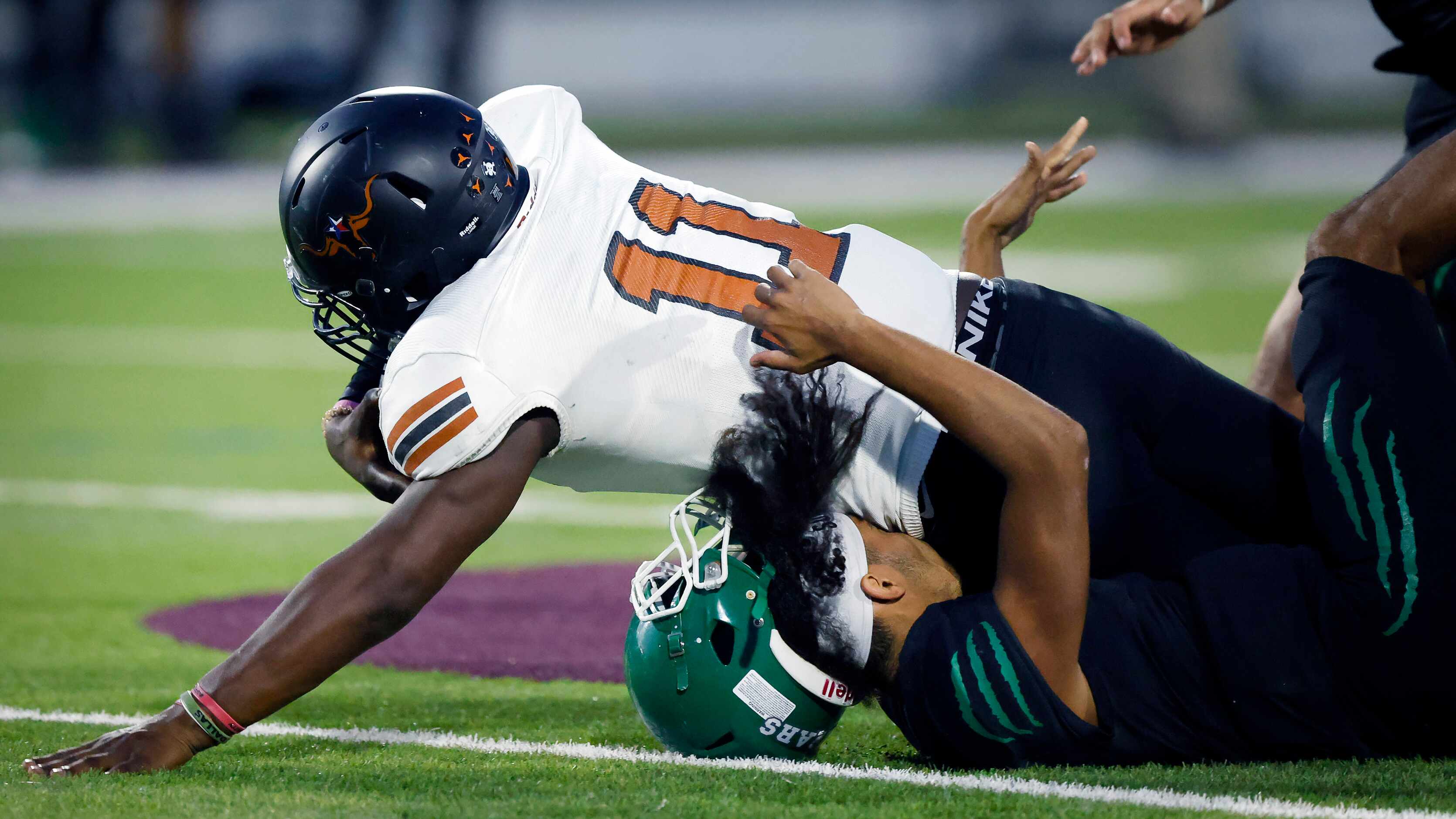 W.T. White linebacker Markavious Justice (11) recovers a fumble and is tackled by a...