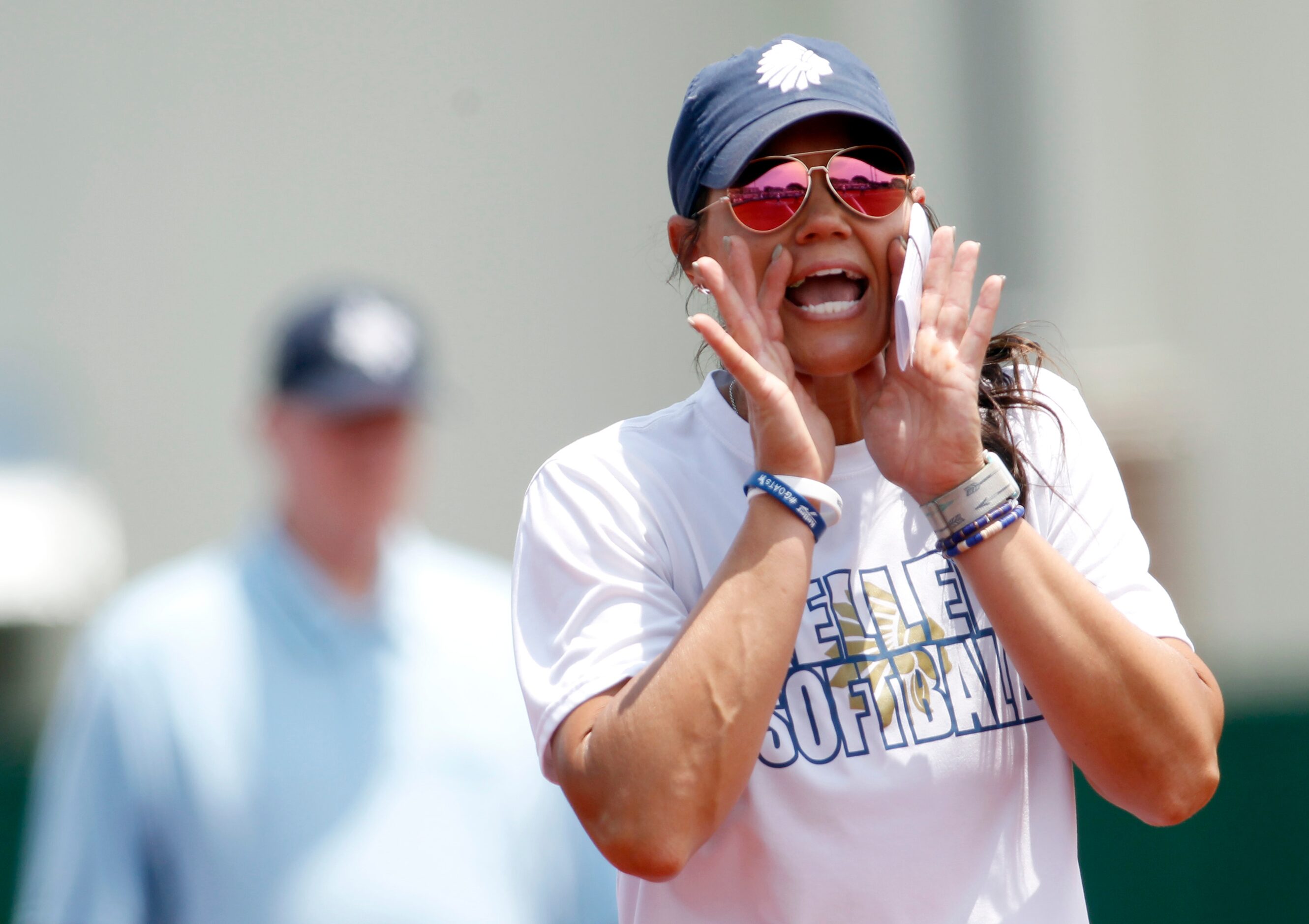 Keller head coach Christina Gwyn delivers a message to a batter during the top of the 3rd...