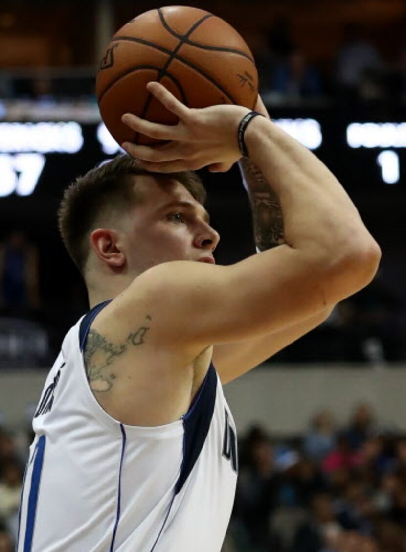 DALLAS, TEXAS – DECEMBER 12:  Luka Doncic #77 of the Dallas Mavericks takes a shot against...