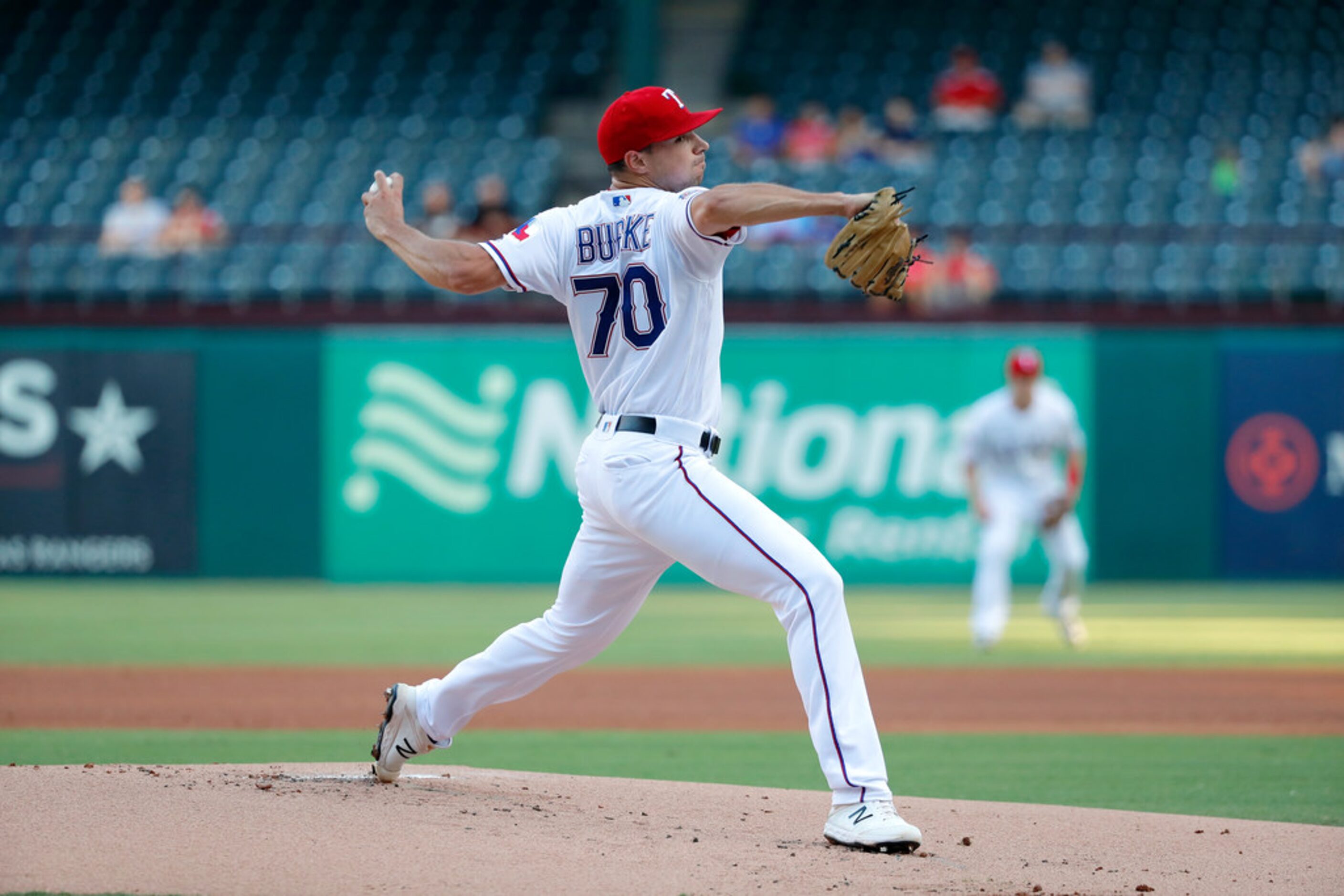 Texas Rangers starting pitcher Brock Burke throws to the Los Angeles Angels in the first...