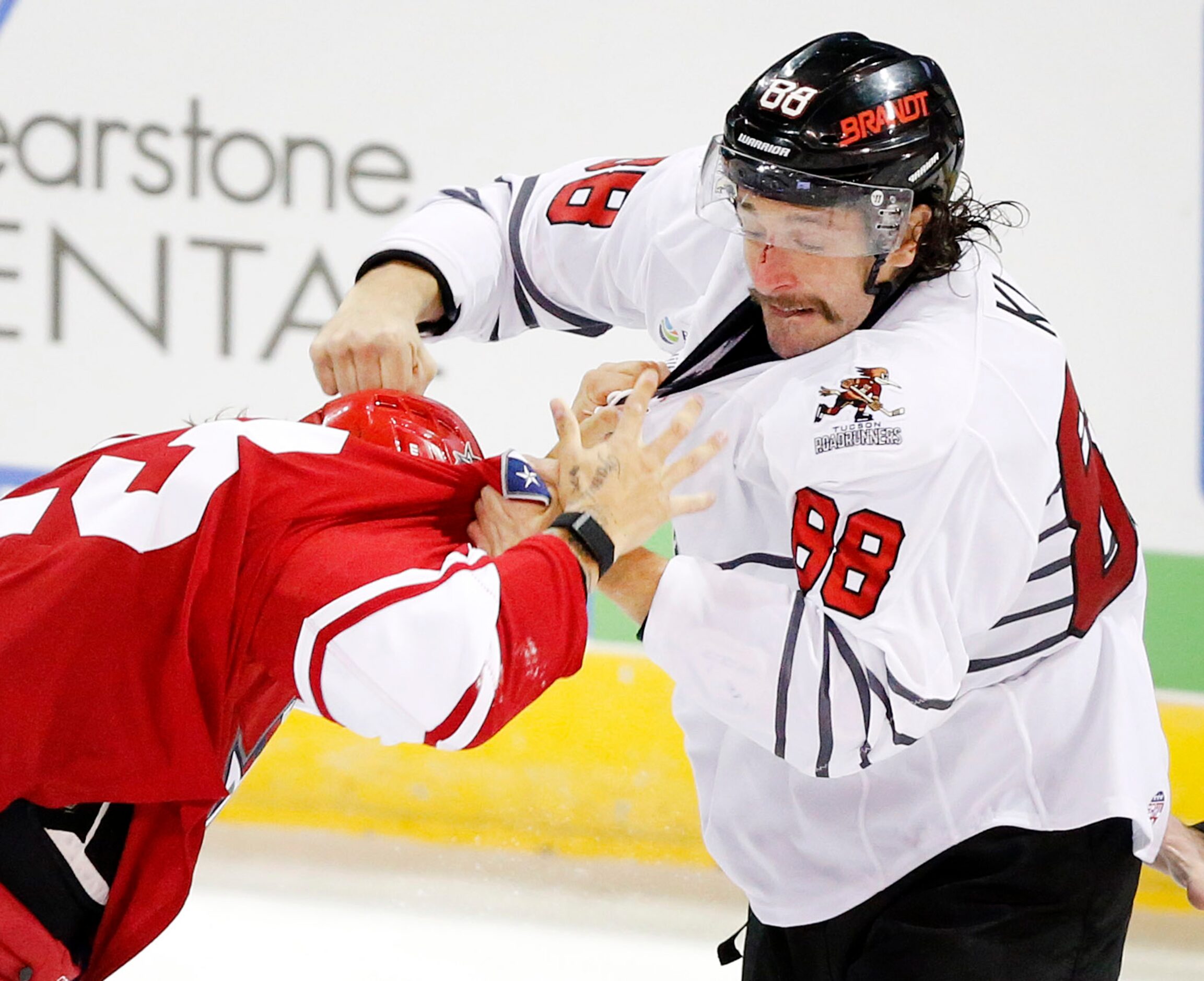 Allen Americans defenseman Cole Fraser (23) and Rapid City Rush forward Garrett Klotz duke...