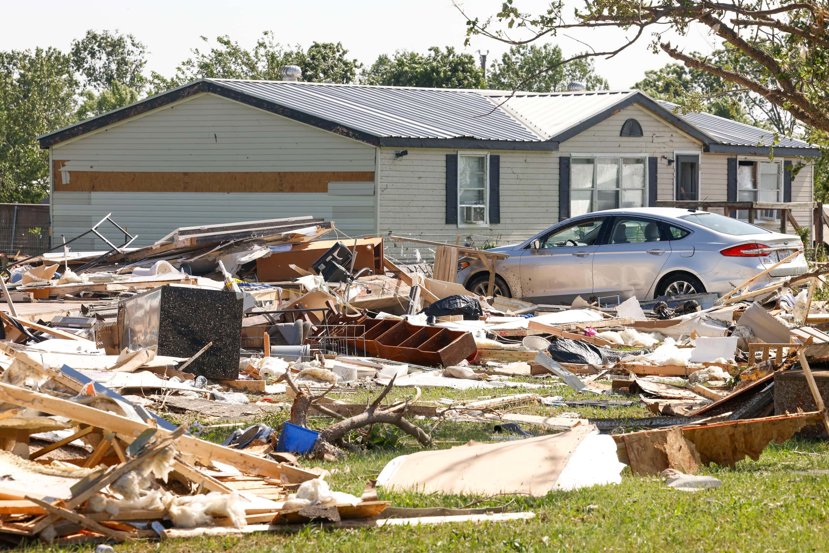 Debris collected by a destroyed house, on Sunday, May 26, 2024, along W Lone Oak Rd. in...