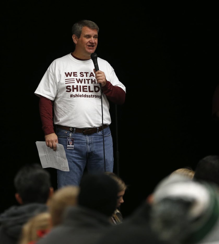 Red Oak ISD Superintendent Scott Niven speaks to parents and students during a prayer vigil...