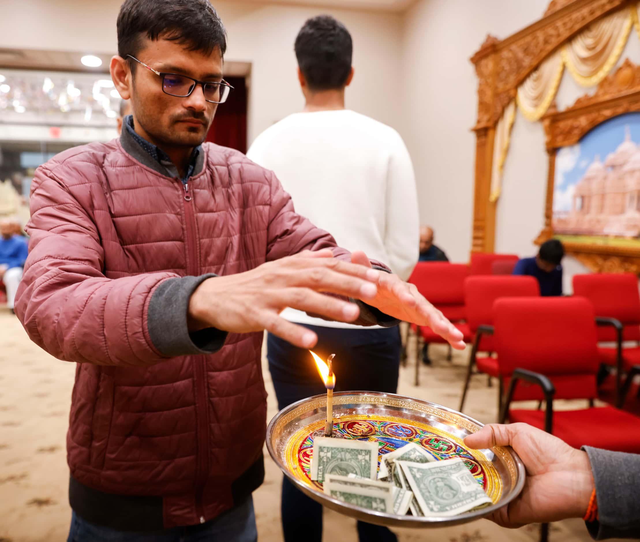 A parishioner gets his blessing after a ritual during a birthday celebration of Lord Ram and...