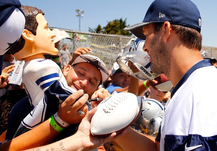 Dallas Cowboys fan Alex Hurtado of San Diego (left) is tickled with joy as Dallas Cowboys...