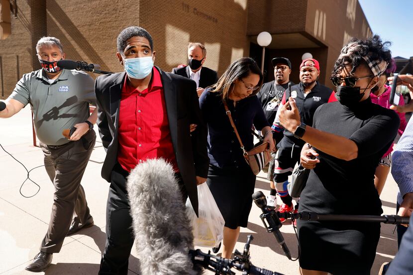 With his wife Eboni Samuel Riser by his side, former Dallas police officer Bryan Riser walks...