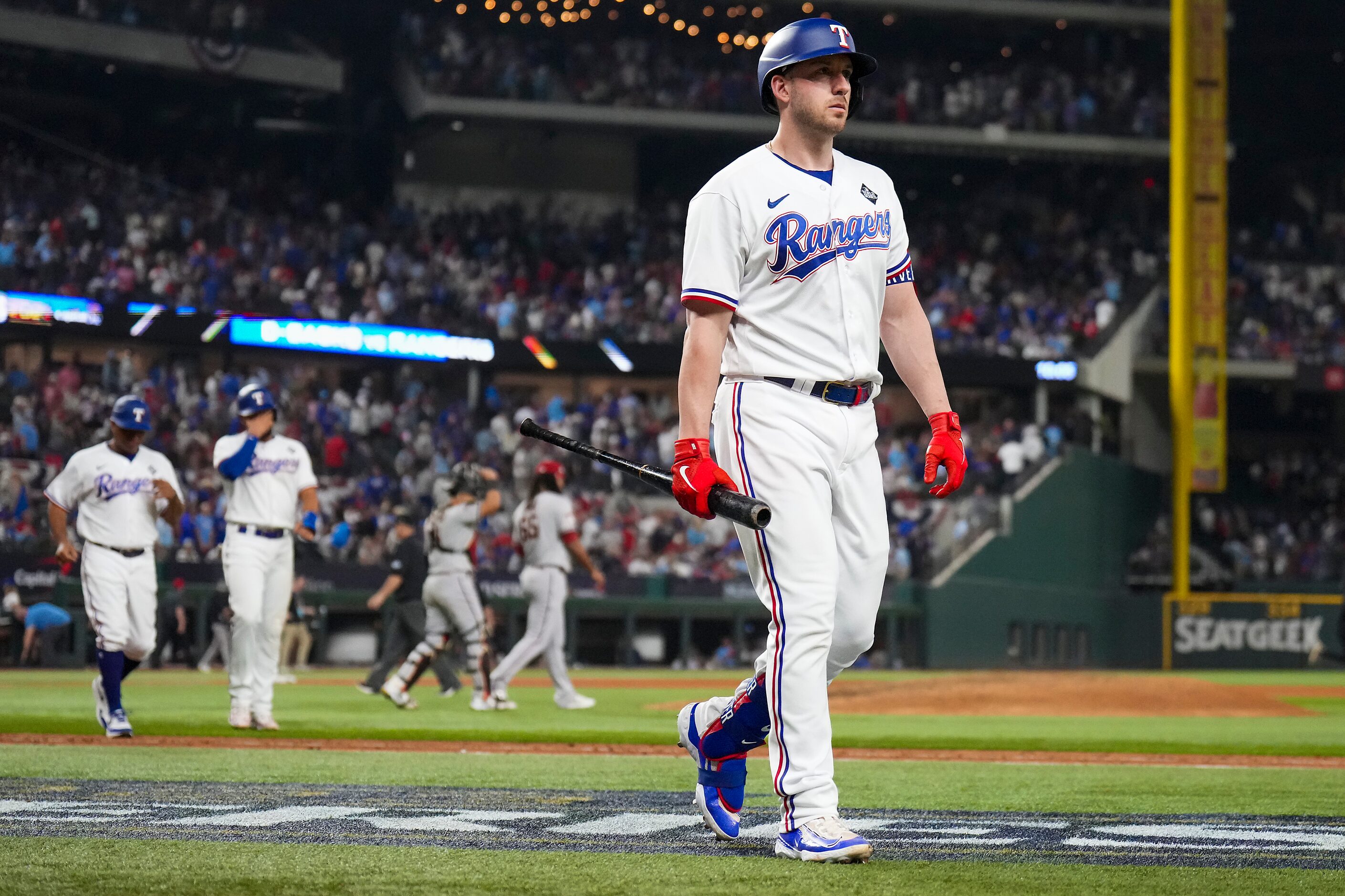 Texas Rangers designated hitter Mitch Garver walks to the dugout after lining out to Arizona...