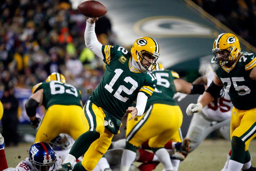 Green Bay Packers quarterback Aaron Rodgers (12) scrambles during the second half of an NFC...