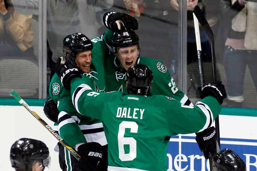 Dallas Stars' right wing Brett Ritchie (25) celebrates with left wig Travis Moen (27) and...