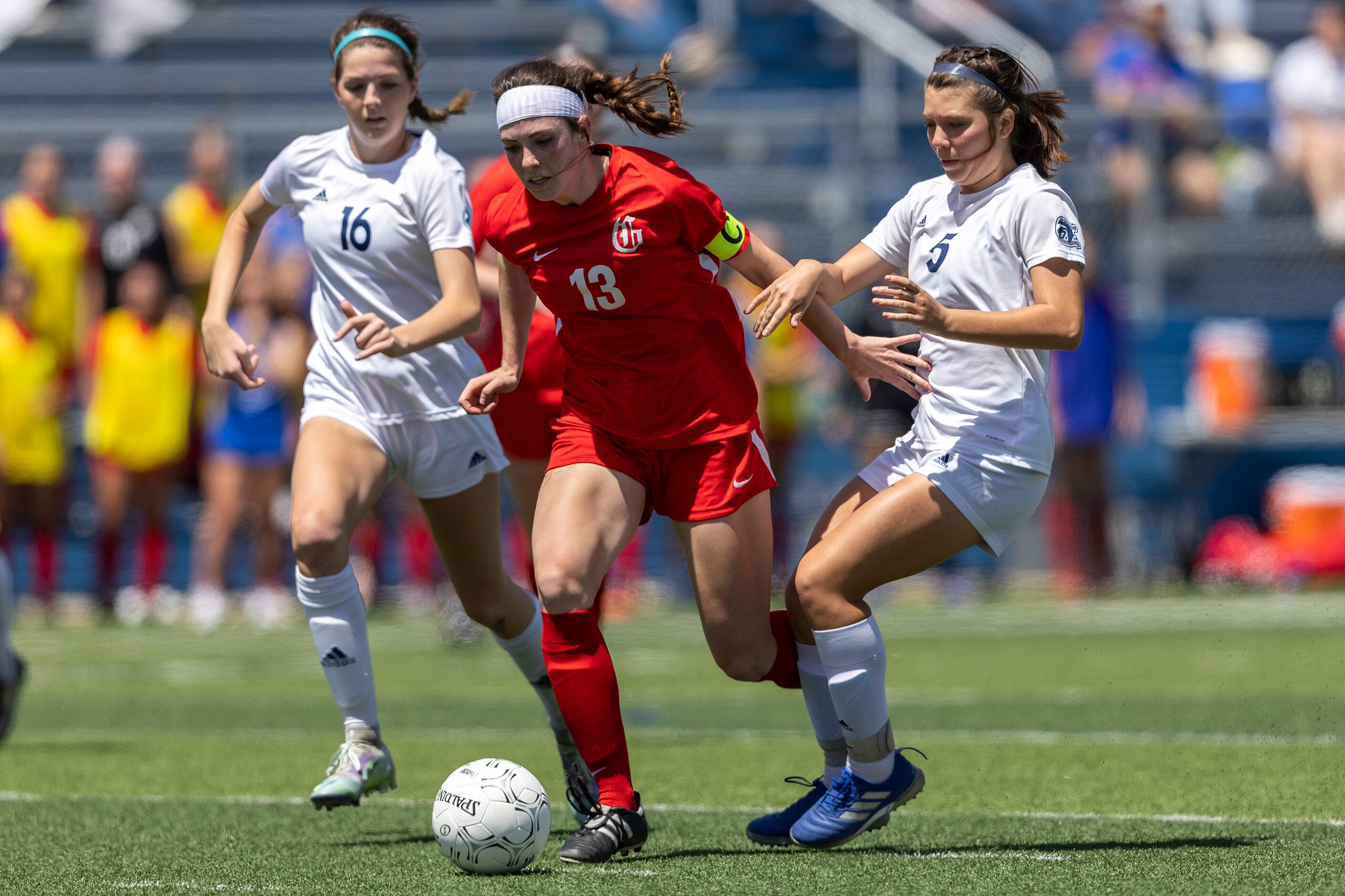 Grapevine midfielder Kasten Merrill (13) drives between Boerne Champion midfielders Addy...