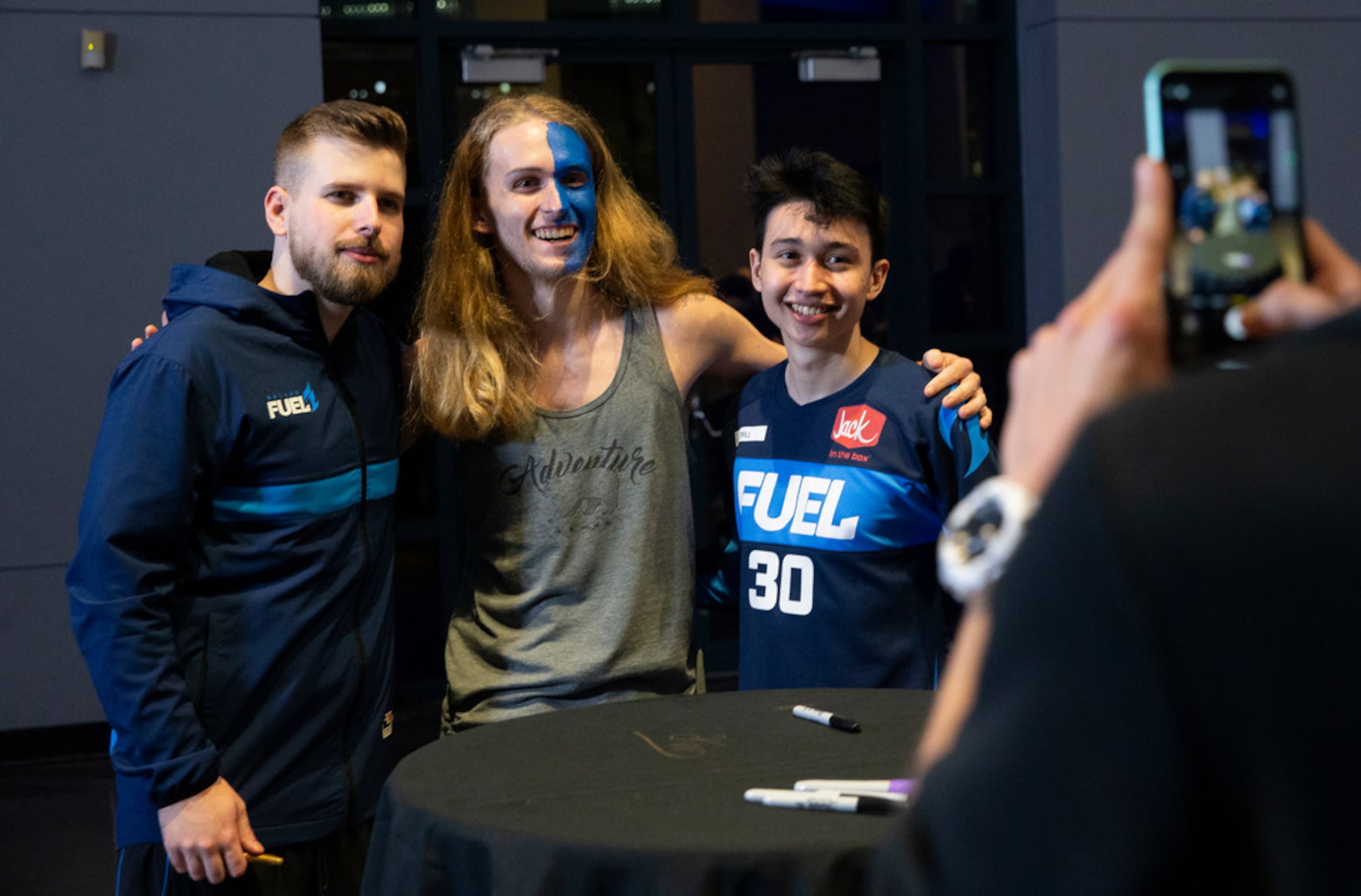 Cameron Ditzler from York, PA takes a photo with the Dallas Fuel following their 3-1 loss to...