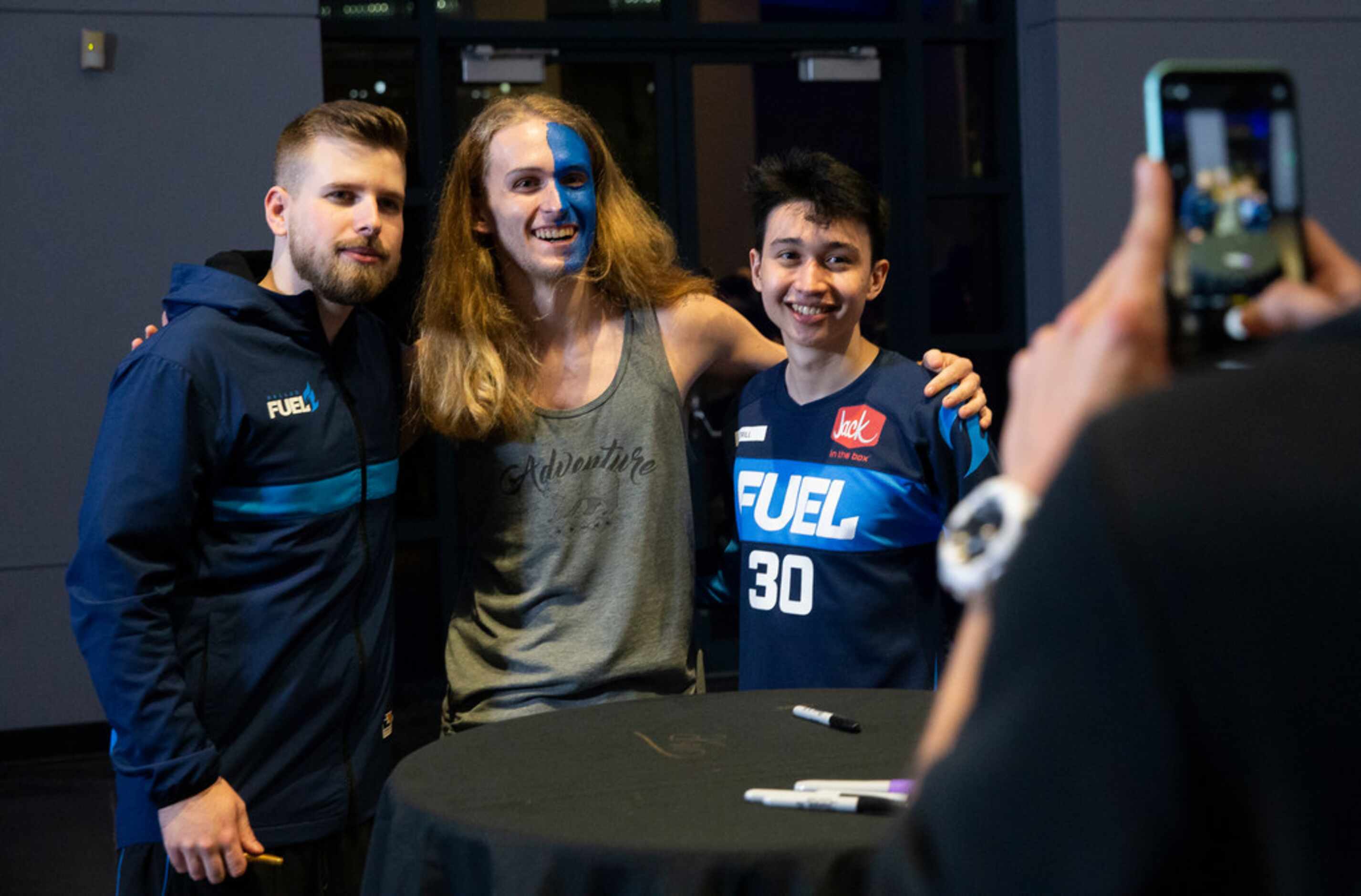 Cameron Ditzler from York, PA takes a photo with the Dallas Fuel following their 3-1 loss to...