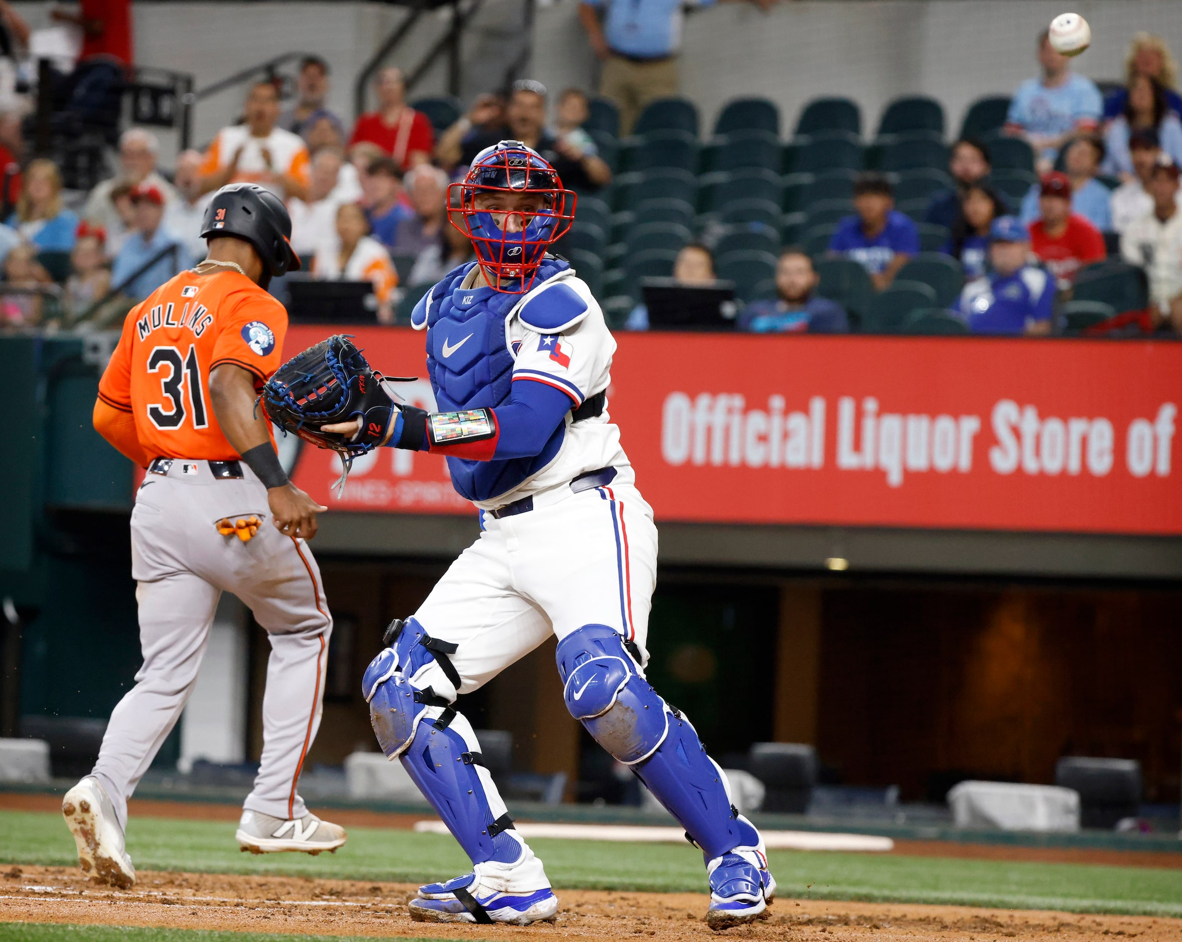 Texas Rangers catcher Andrew Knizner (12) has the throw in from centerfield bounce off his...