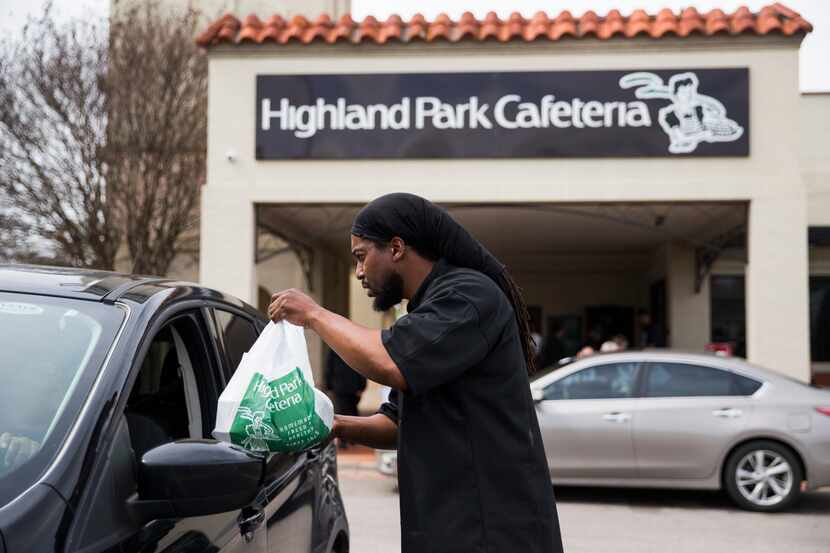 Executive Chef Johnny Howard delivers a meal to a driver outside Highland Park Cafeteria on...