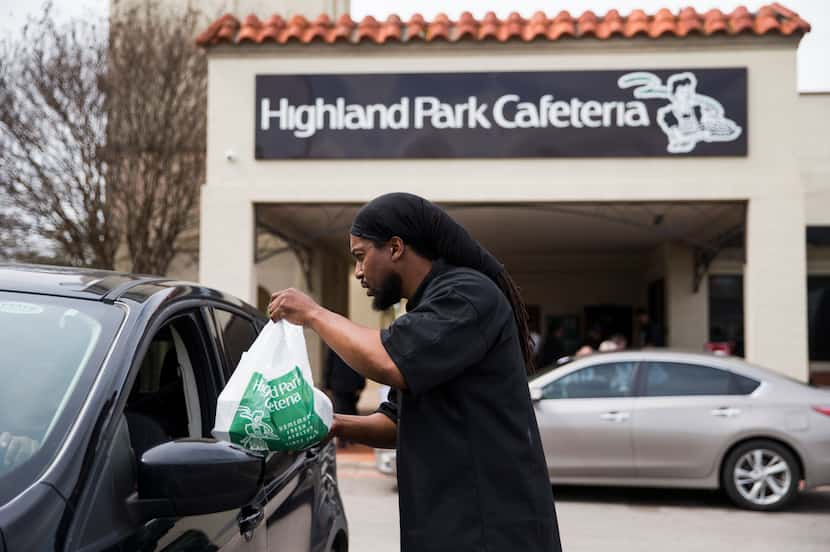 Executive Chef Johnny Howard delivers a meal to a driver outside Highland Park Cafeteria on...