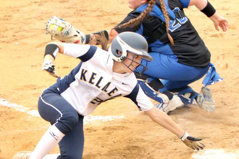 Keller outfielder Caraline Woodall (21) reaches for home plate as she beats the throw and...