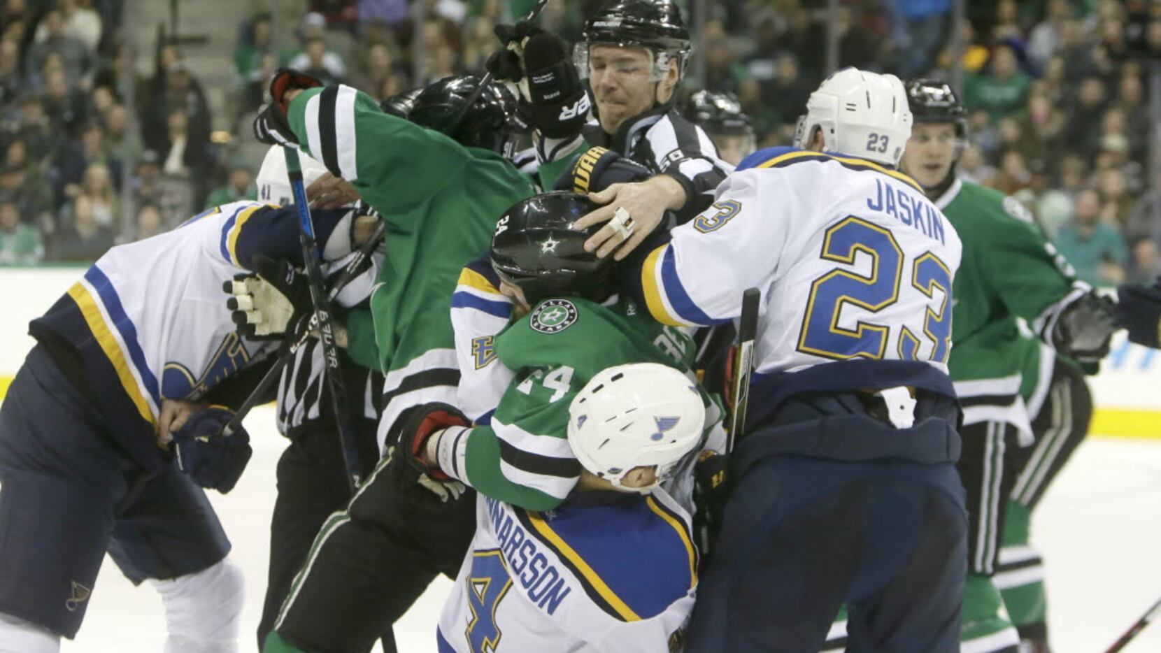 St. Louis Blues and Dallas Stars players tangle during the first period of an NHL hockey...